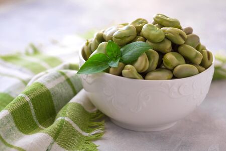 Boiled green beans on plate. Close up of boiled green beans on plate healthy and vegan dish with leaf of basil.の写真素材