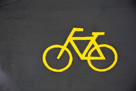 Photo of bicycle yellow sign on groundの写真素材