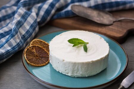 Photo of cheesecake with decorated with mint and flowers. Healthy organic summer dessert pieの写真素材