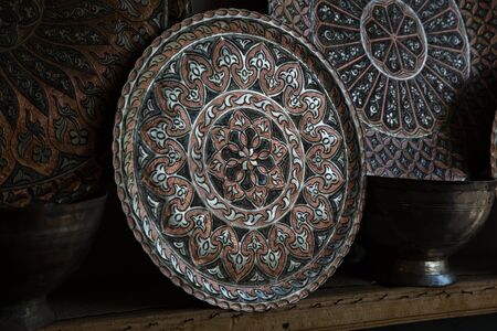 Copper plate handcrafted, traditionally made in Lagich, Azerbaijan. Handmade plate in souvenir shopの写真素材