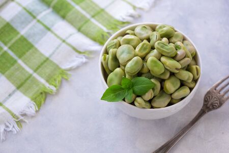 Boiled green beans on plate. Close up of boiled green beans on plate healthy and vegan dish with leaf of basil.の写真素材