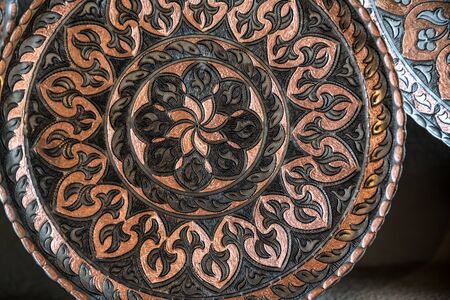 Copper plate handcrafted, traditionally made in Lagich, Azerbaijan. Handmade plate in souvenir shopの写真素材