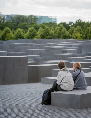 BERLIN, GERMANY - JUNE 2, 2006: A pair of tourists sit to admire and contemplate over the Holocaust Memorial in Berlin, Germany.のeditorial素材
