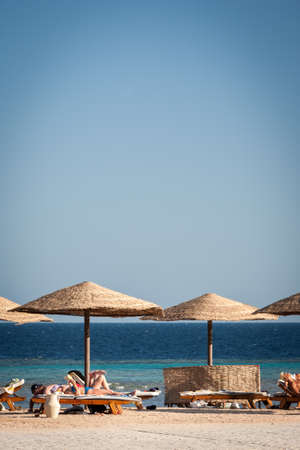 HURGHADA, EGYPT - NOVEMBER 21, 2006: Tourists lazing on sun loungers on the  coast of Red Sea near Hurghada, Egypt.のeditorial素材