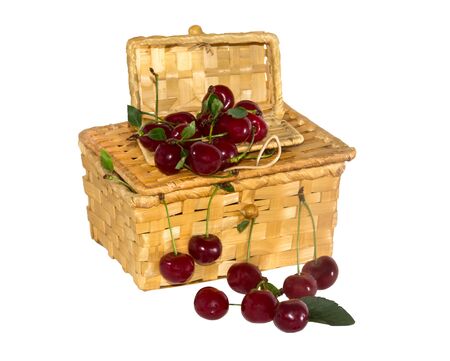 wicker basket with ripe cherries on a white backgroundの写真素材