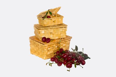 three wicker baskets baskets with cherries on a white backgroundの写真素材