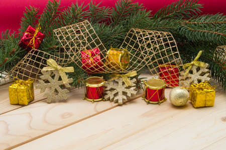 Holiday background with pine branches and toys on a wooden table の写真素材