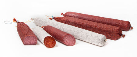 Salami different sorts of sausages on white backgroundの写真素材