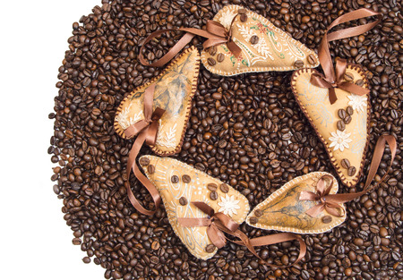 Two hearts, decorated with ribbons and coffee on a background coffee grainsの写真素材