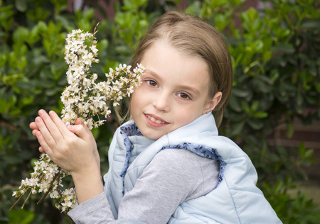 Portrait of beautiful little girl in springtimeの写真素材