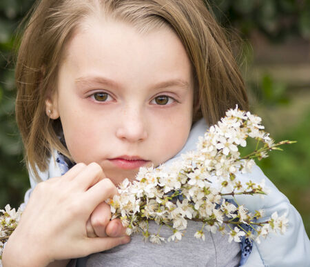 Portrait of beautiful little girl in springtimeの写真素材
