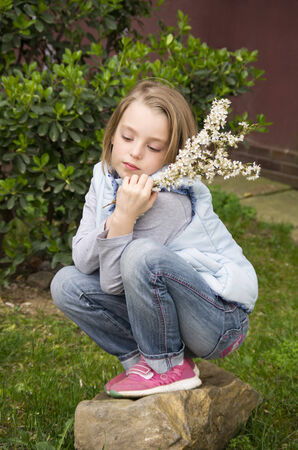 Portrait of beautiful little girl in springtimeの写真素材