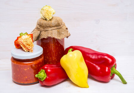 Assortment of sweet pepper and sauce with him on a wooden table.の写真素材