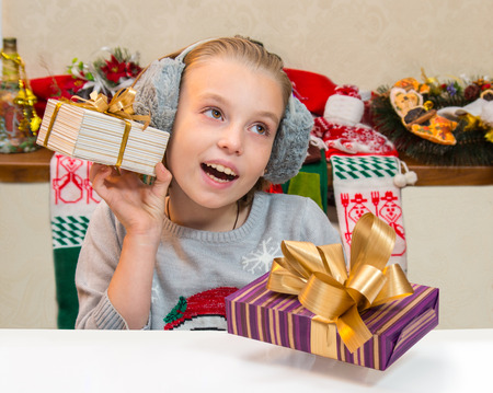 Very happy little girl with gift box for Christmas.の写真素材