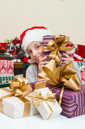 Very happy little girl in Santa hat with gift box for Christmas.の写真素材