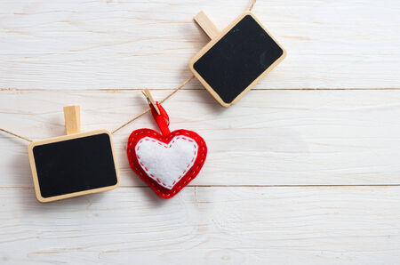 Blank plate for writing text with hearts on the clothespin on wooden background.Symbol of love.の写真素材