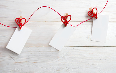 Blank card for text with clothespins hearts on wooden background.Symbol of love.の写真素材
