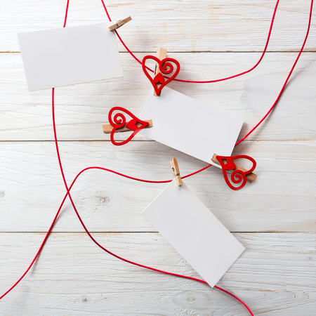 Blank card for text with clothespins hearts on wooden background.Symbol of love.の写真素材