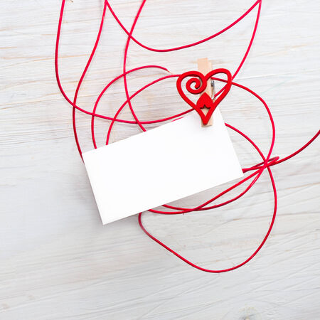 Blank card for text with clothespins hearts on wooden background.Symbol of love.の写真素材