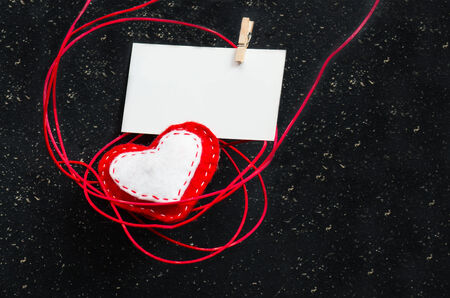 Heart of fabric on a black background with a blank for your text. Symbol of love.Valentine's idea.の写真素材