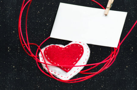 Heart of fabric on a black background with a blank for your text. Symbol of love.Valentine's idea.の写真素材