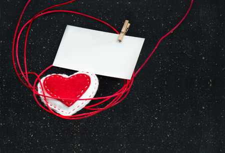 Heart of fabric on a black background with a blank for your text. Symbol of love.Valentine's idea.の写真素材