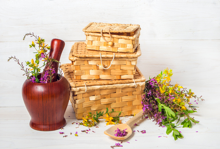 fresh healing herbs and boxes for their storageの写真素材