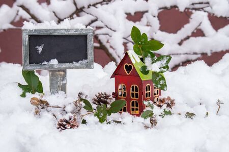 Plate for inscriptions in chalk and decorative lantern in the snow  in winter dayの写真素材