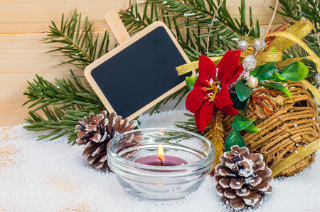 Christmas composition with tablets for text and a burning candle on the wooden backgroundの写真素材