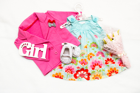 Set of clothes for the little girl. Pink jacket, dress, booties.の写真素材