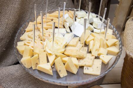 slicing cheese platter on a wooden plateの写真素材
