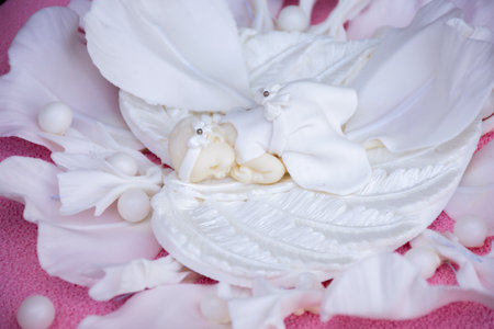 sculpture of an angel on a white flower. cake decorationの写真素材