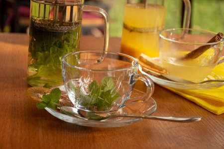 ginger sea buckthorn tea with cinnamon sticks and honey on a wooden tableの写真素材
