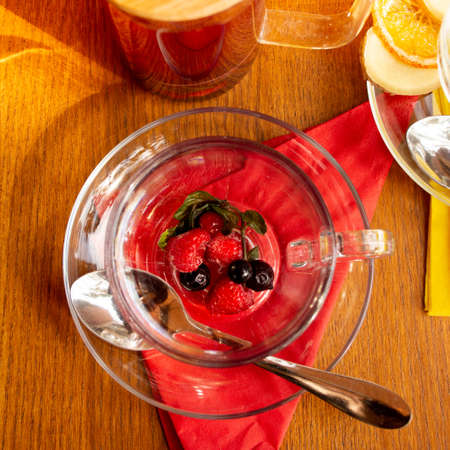 ginger sea buckthorn tea with cinnamon sticks and honey on a wooden tableの写真素材