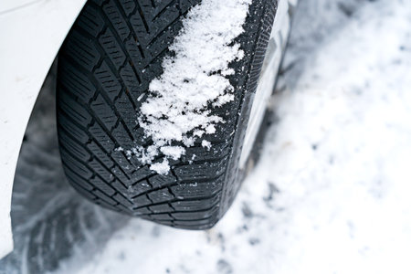 Winter car tire on snow and tread in snow. Close-up of car tires in winter.の写真素材