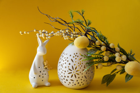 Easter white egg and white flower; bouquet; tulip; spring; holiday; background; gift; beautiful; bloom; copy; text; yellow; red; flowers; holiday; bloom; nature; fresh; design; day; decoration; card; space; white; table; floral; green; March with branch and with Easter eggs on yellow background. Happy Easter with place for text.の写真素材