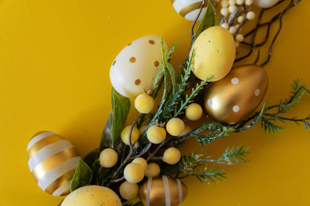 branch with Easter eggs on a yellow background. Happy Easter with place for text