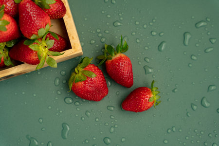 Freshly washed strawberries on a green background with water drops filled with berries. Diet. Seasonal berries.の写真素材