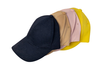 Pink, blue, yellow and beige cap, top view, isolated on white background. Four caps stacked one after another, mockup for logo placement.の写真素材