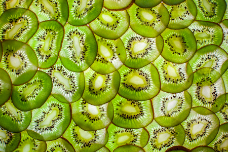 Slim slices kiwi fruit. Background.の写真素材