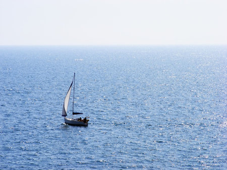 Sailing boat floats on the high seas clear sunny day