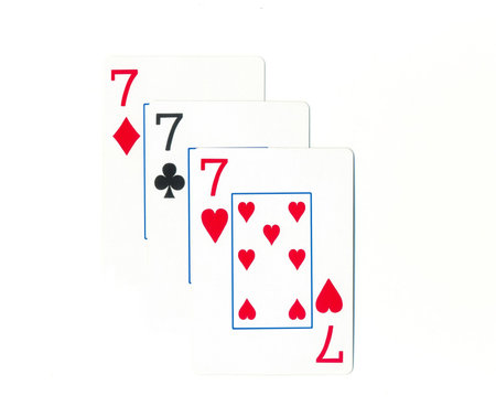 Playing cards of different colors on the table isolated on white background