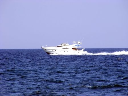 Marine boat is moving rapidly to large areas of sea waterの写真素材