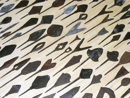 The collection of arrowheads located in neat rows on a light backgroundの写真素材