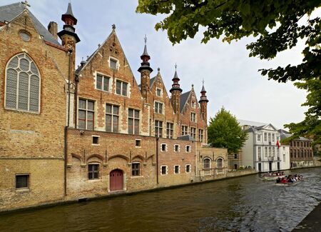 Medieval buildings and canal in Bruggeのeditorial素材