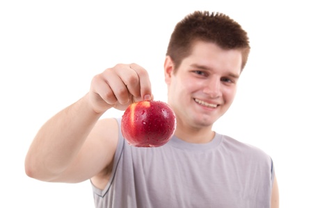 young healthly man shows red apple isolated on whiteの写真素材