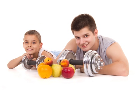 a boy and a man resting after exercise with fruitの写真素材
