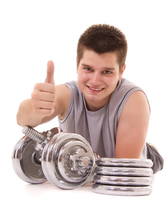  young man exercising with a dumbbell and pointing OKの写真素材