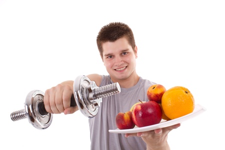 healthy young men exercise and hold fruitsの写真素材