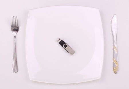 usb stick on a plate with knife and forkの写真素材